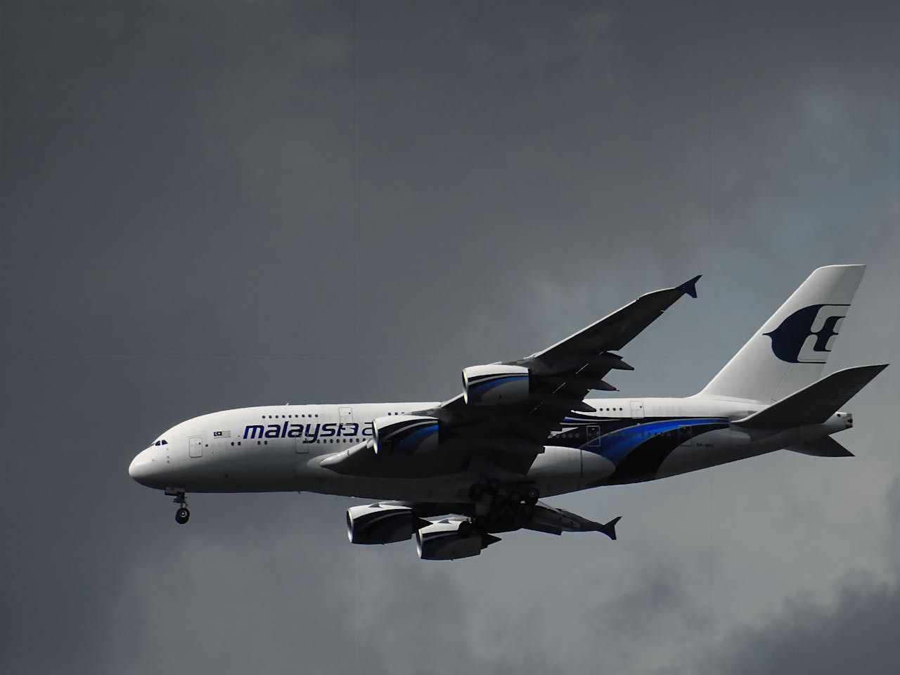 gallery-05 An Airbus A380 from Malaysia Airlines cruising through dark, cloudy skies.