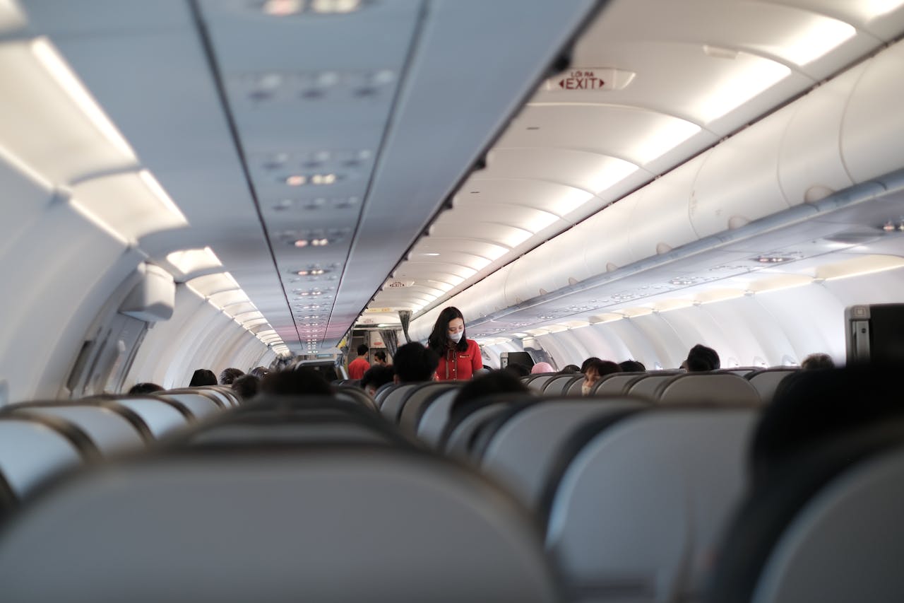 gallery-06 Passengers and flight attendant inside a Vietnam commercial aircraft. Travel safety with masks.