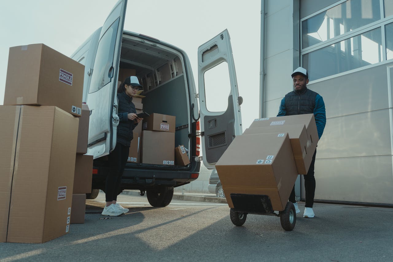portfolio-05 Two couriers load boxes into a van for shipment, showcasing logistics and teamwork.